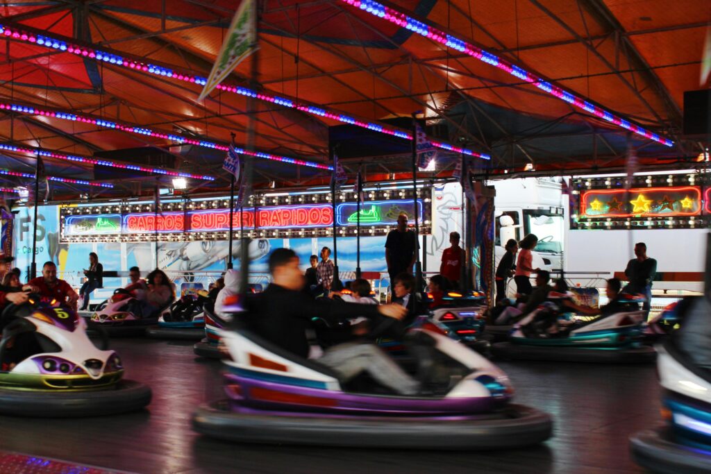 Exciting nighttime bumper car ride at a lively fair illuminated by colorful lights.