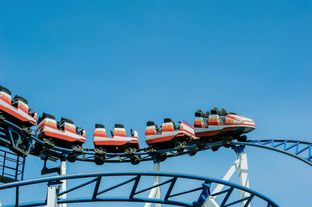 Exciting roller coaster ride with vibrant colors against a clear blue sky.